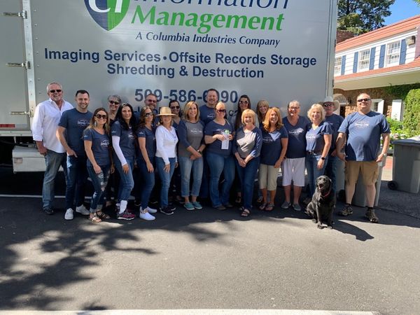 YAKIMA REALTOR DAY4 Group of people standing in front of a sign